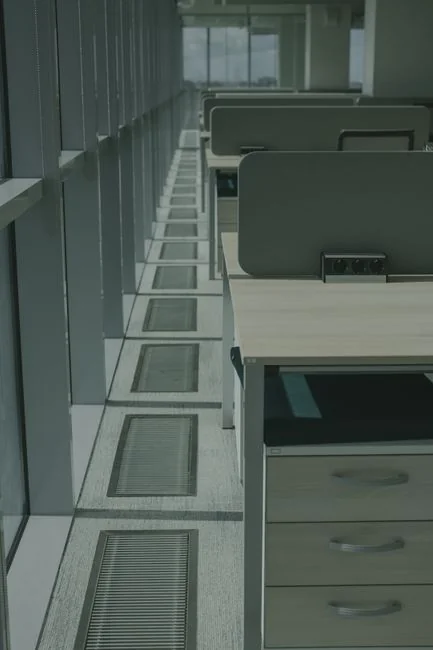 Overhead shot of cardboard cartons filled with belongings arranged on the floor inside a newly rented apartment